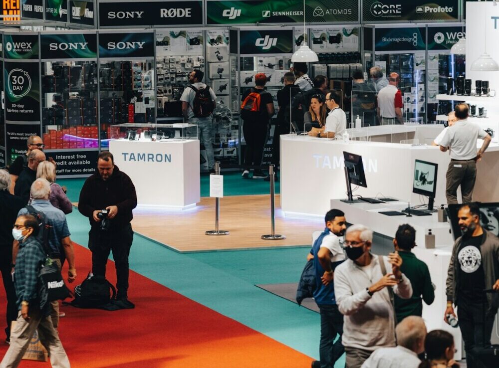 a group of people standing around a booth